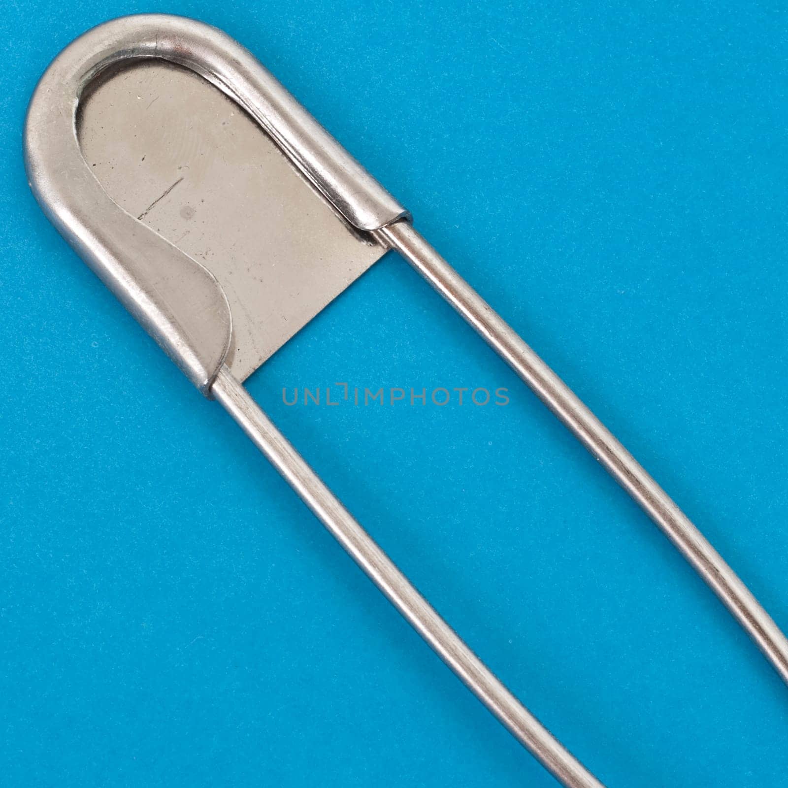 Close Up of Large Safety Pin on a Vibrant Background.  Everyday Object Close Up.