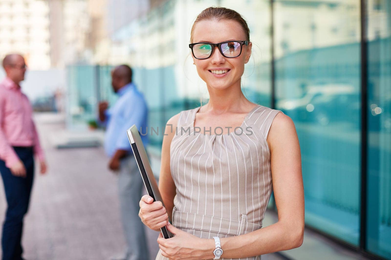 Young businesswoman in eyeglasses holding touchpad