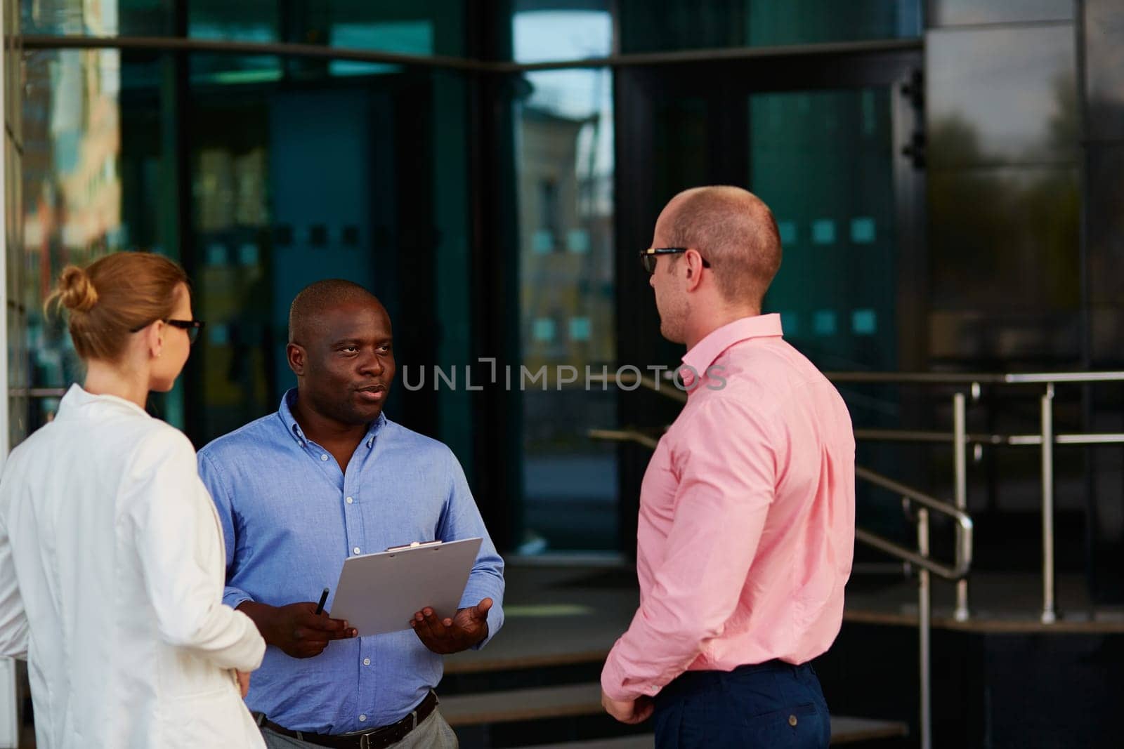 African businessman voicing his ideas upon financial data to colleagues at outdoor meeting