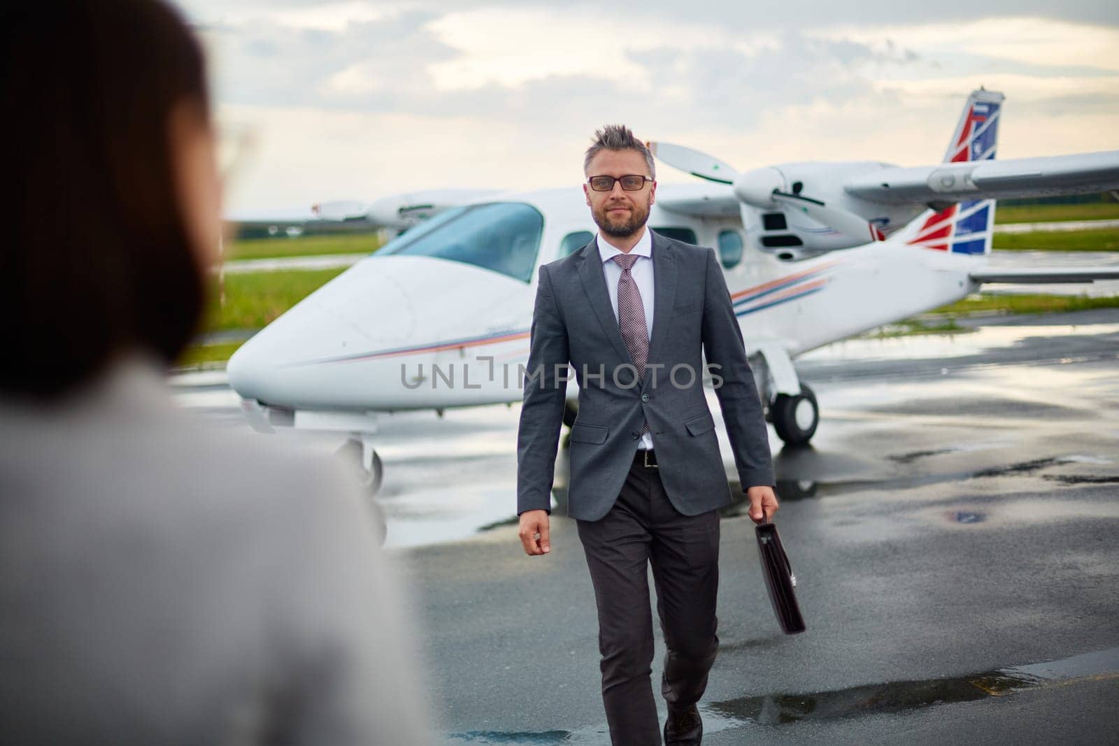 Modern businessman with briefcase hurrying to meet his partner