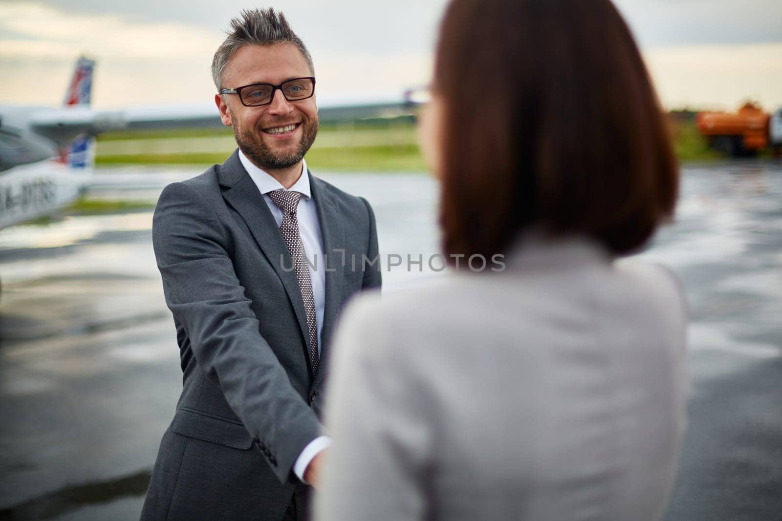 Happy businessman greeting his partner upon arrival