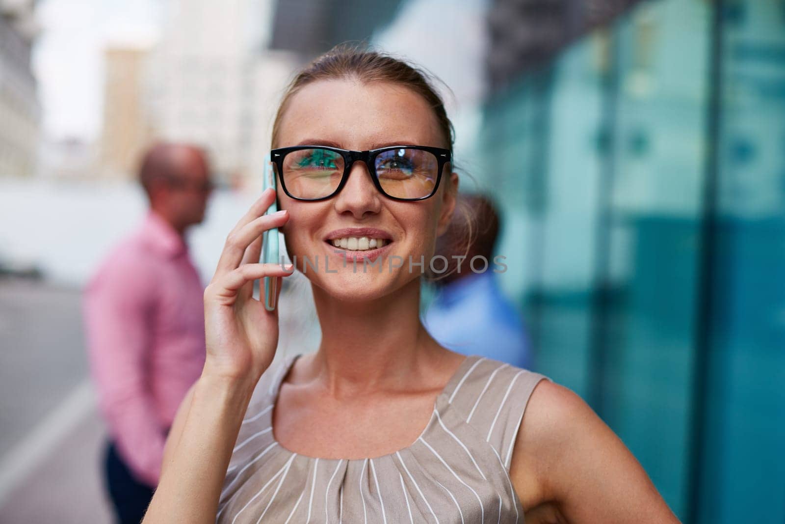 Young businesswoman in eyeglasses speaking on the phone