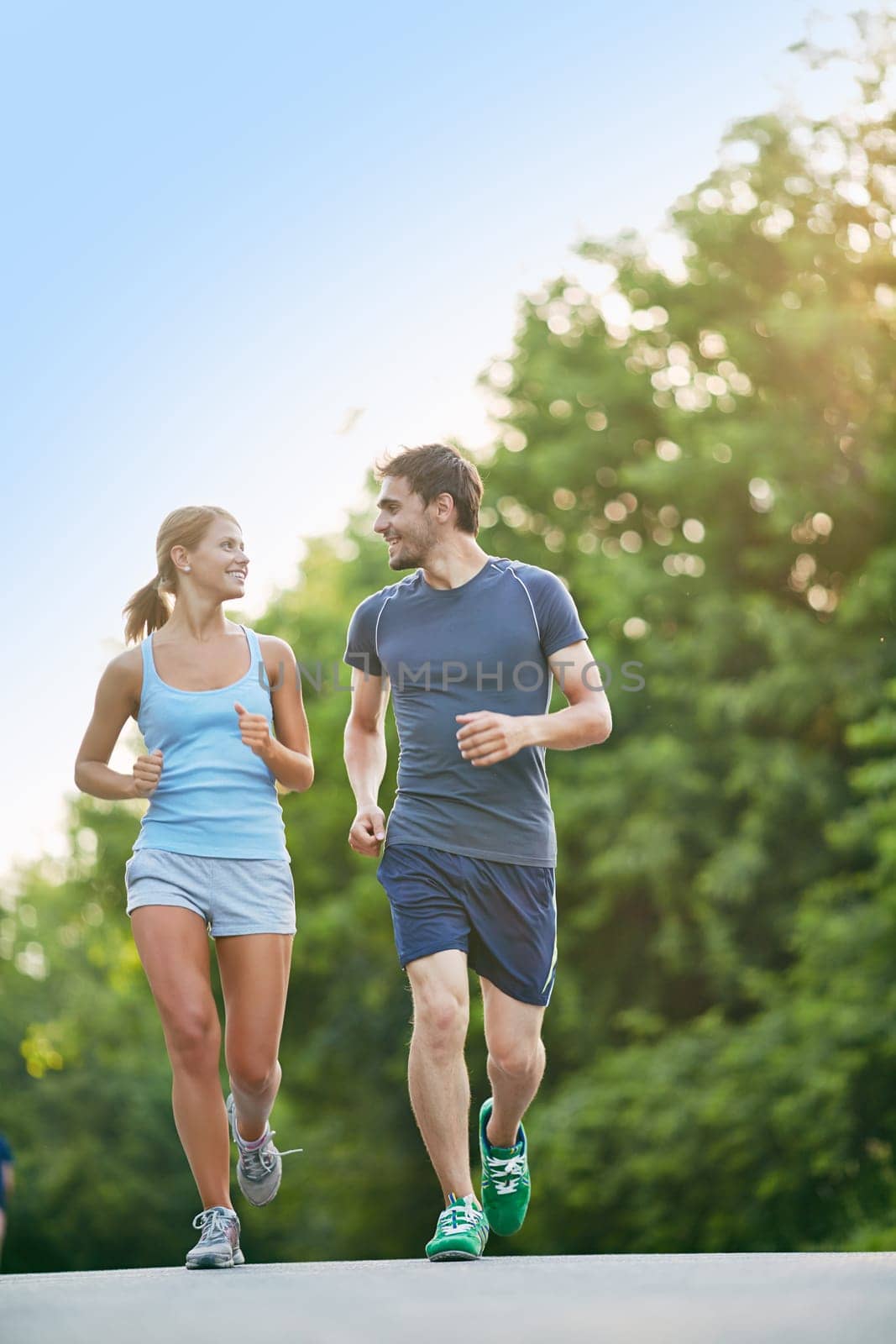 Happy couple running together in park