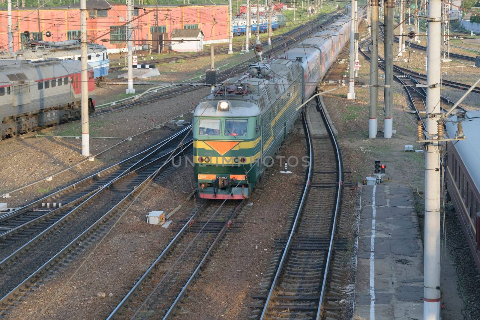 The passenger train arrives at the railway station.