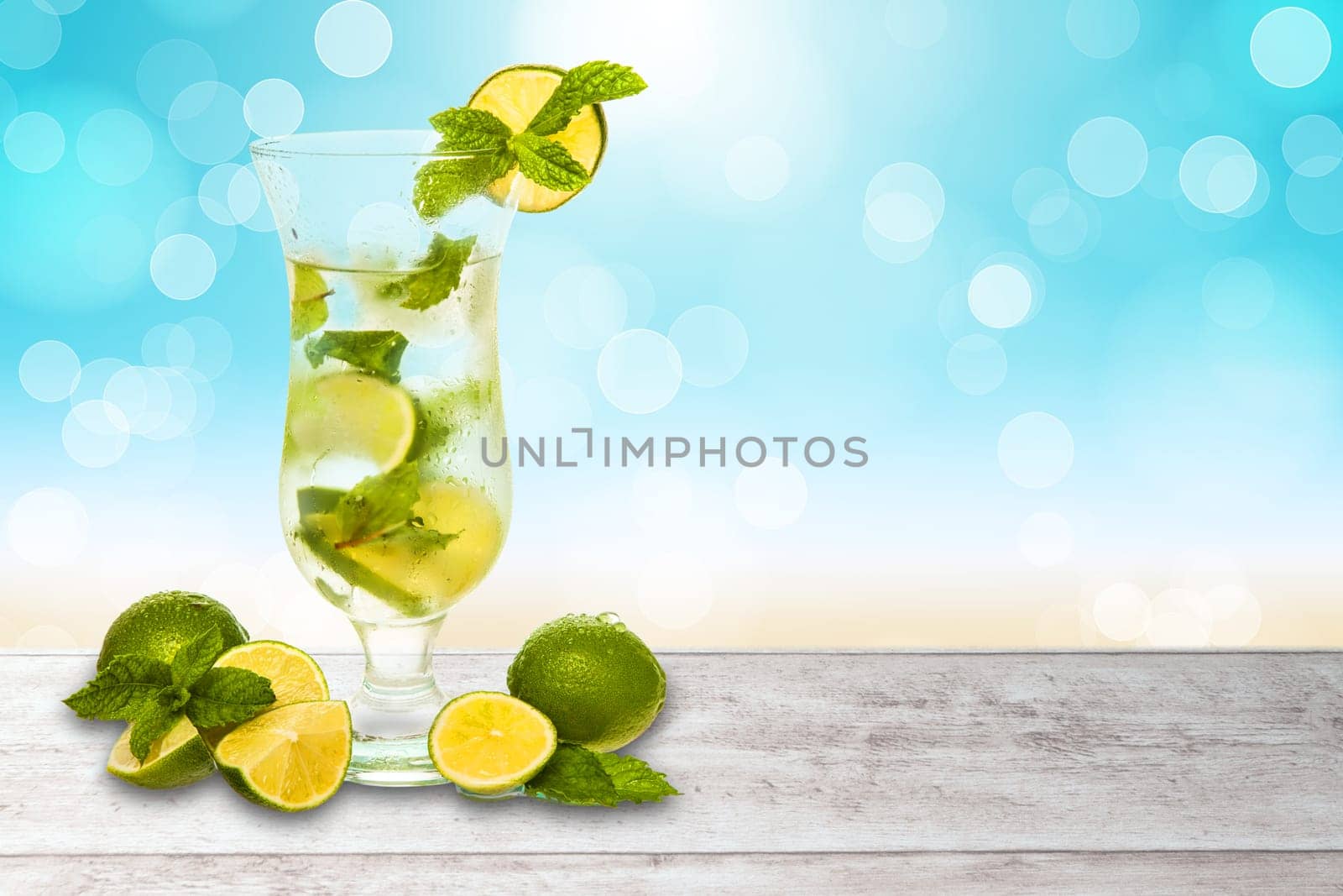 water or cocktail with a blurred beach background