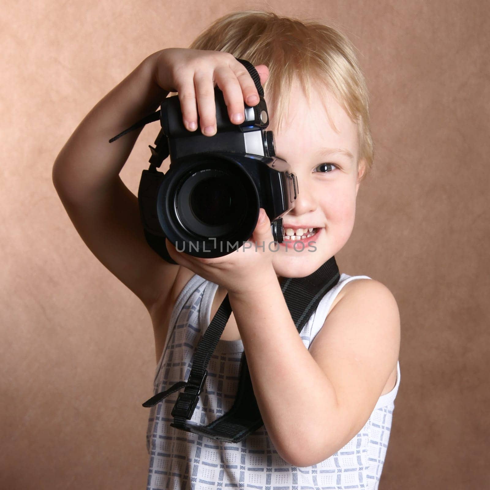 child in studio with professional camera