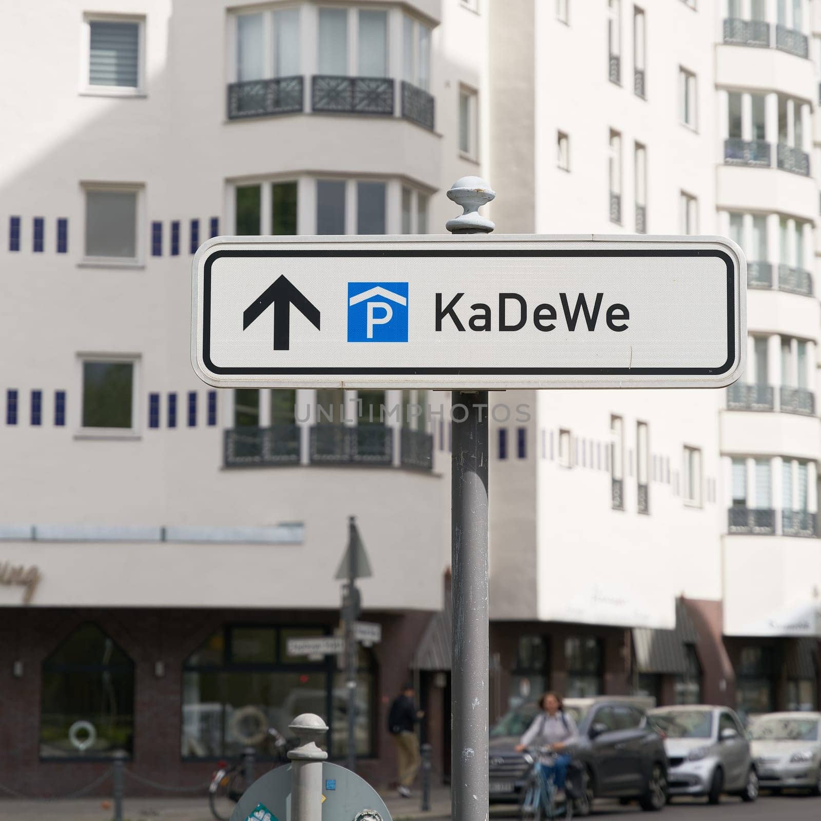 Street sign indicating a parking garage for customers of KaDeWe, Kaufhaus des Westens in Berlin. Translation: Department Store of the West by heiko119