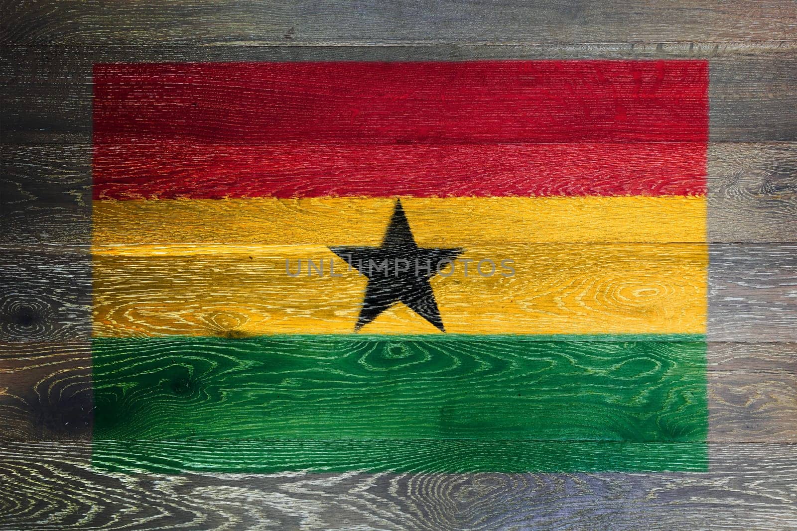 A Ghana flag on rustic old wood surface background