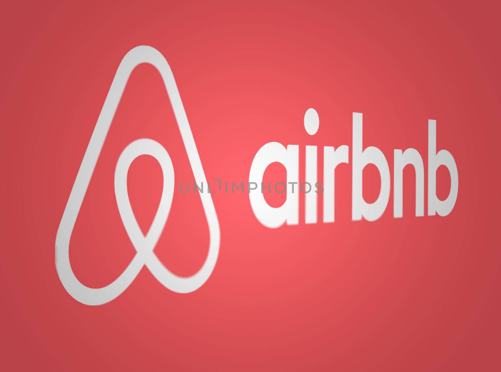 San Francisco, US, March 2023: Airbnb logo on a red background. Airbnb is a platform for booking accommodations. Illustrative editorial illustration. Selective focus
