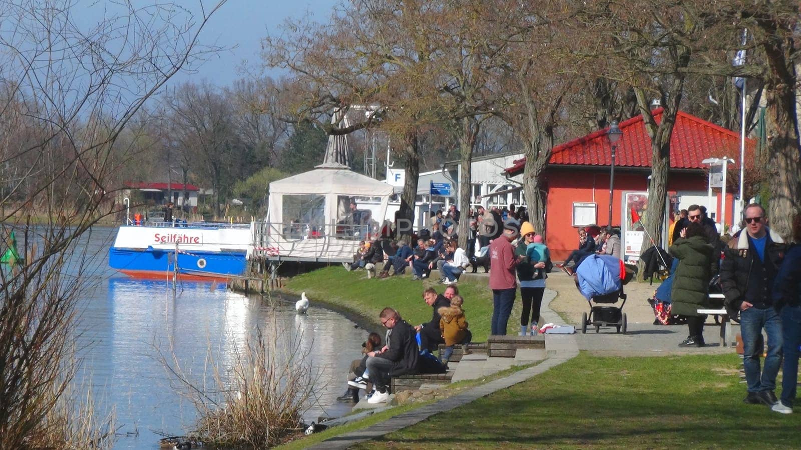 CAPUTH, Germany, Brandenburg, April 0, 2023. The most popular waterfront in Caputh at the river Havel with cable ferry port. The river Havel connects the lake Schwielow with the Templiner lake and is a popular travel destination. Macro.