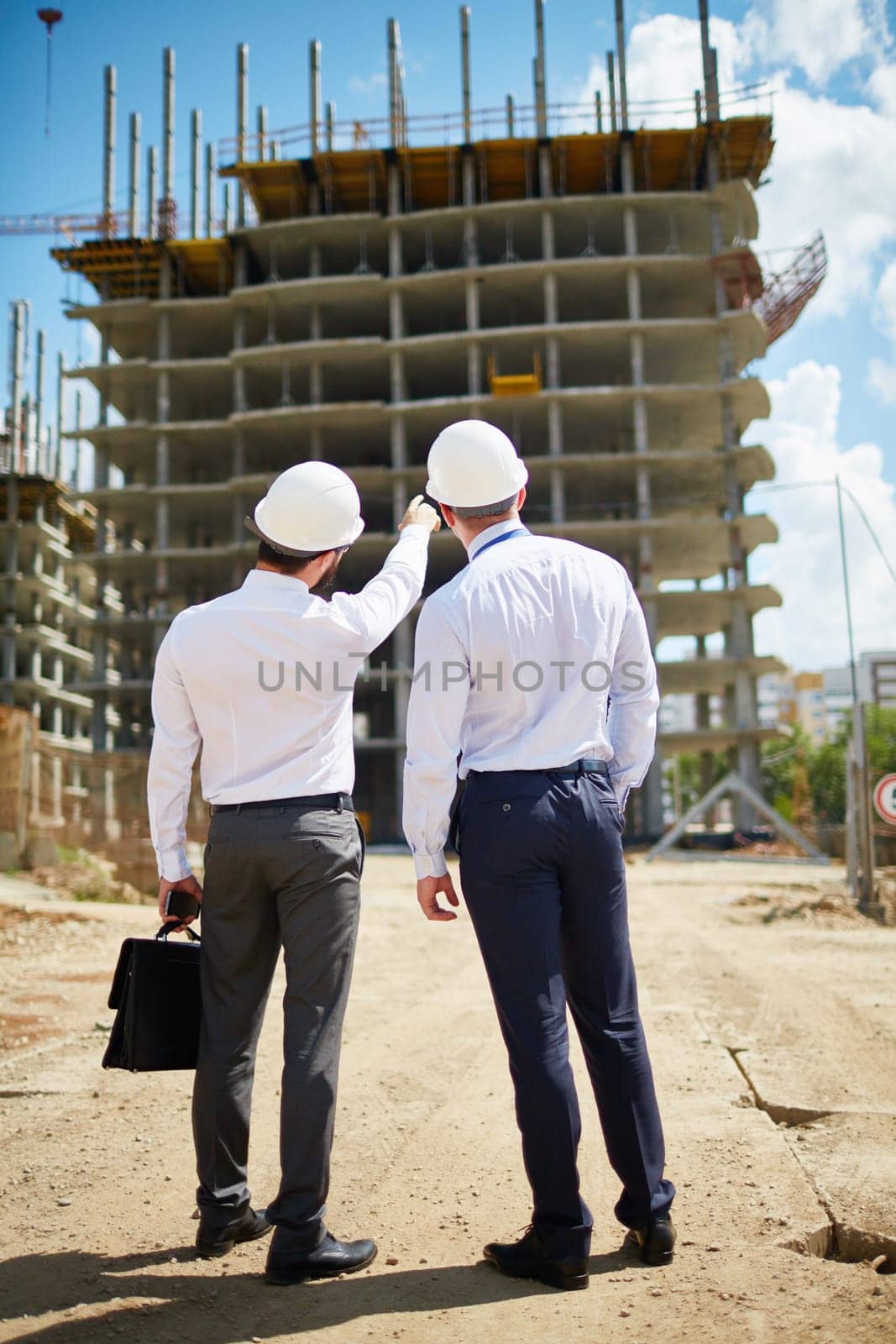 Two architects standing in front of new construction