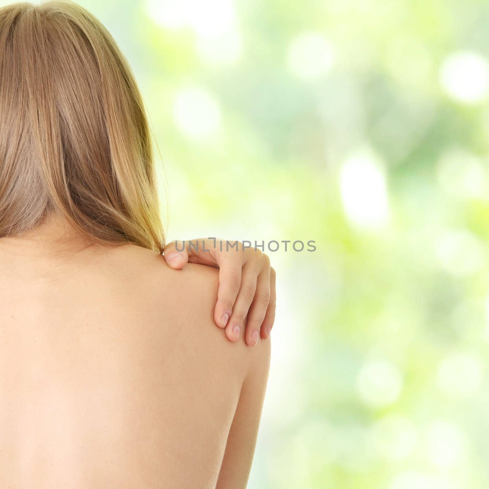 Woman from behind, naked body, pain concept,against abstract green background