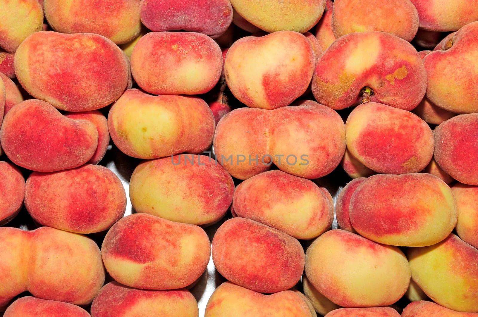 a pile of chinese flat peaches ready to sell