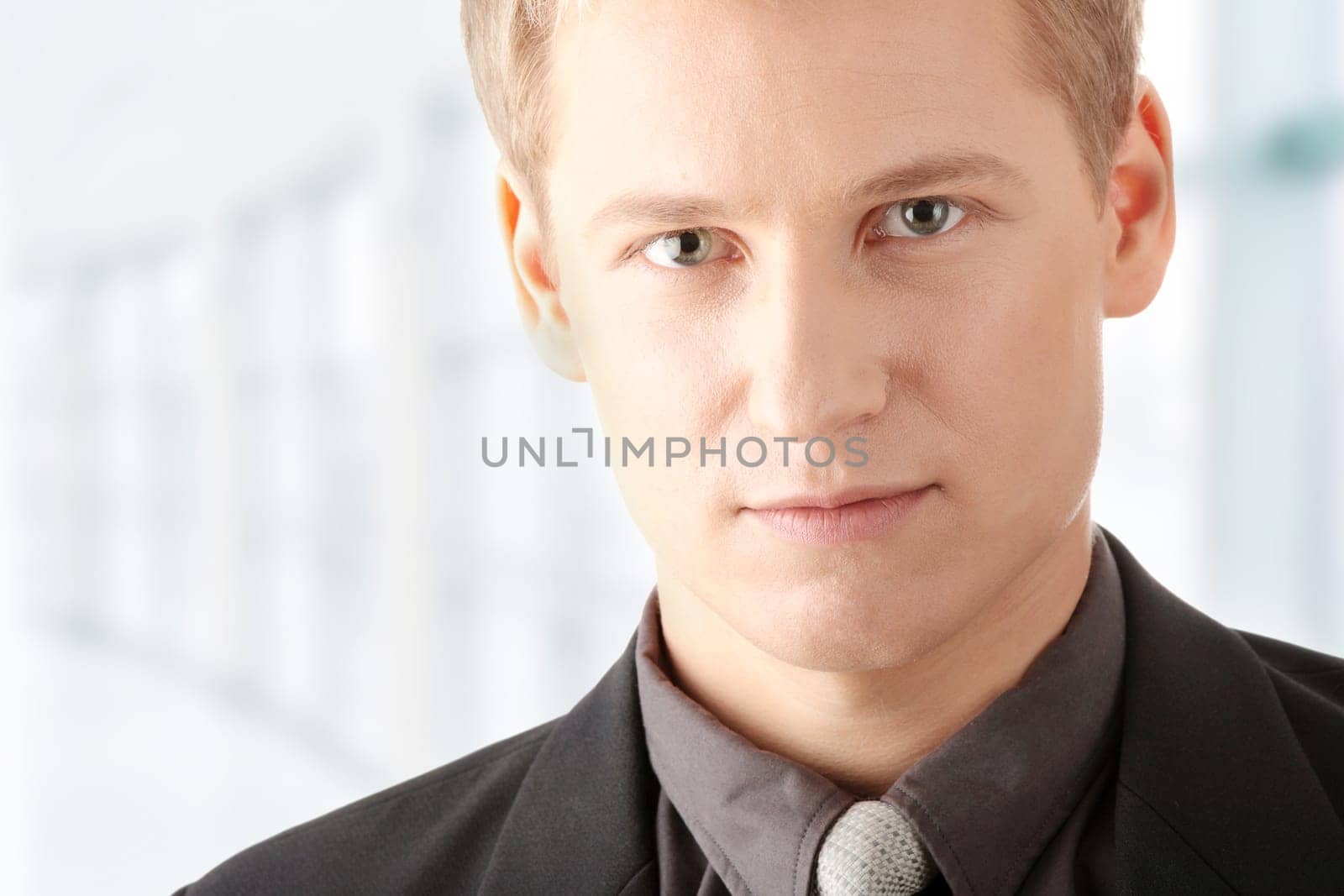 Closeup of a smart handsome business man over white background