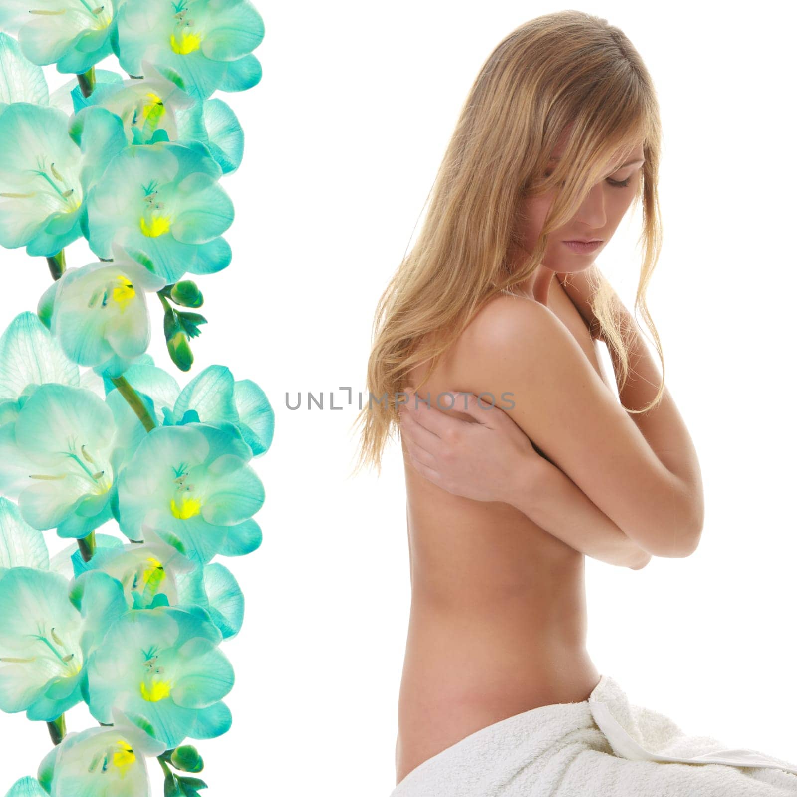 Beautiful young naked woman covered by towel - spa concept, against abstract flower background