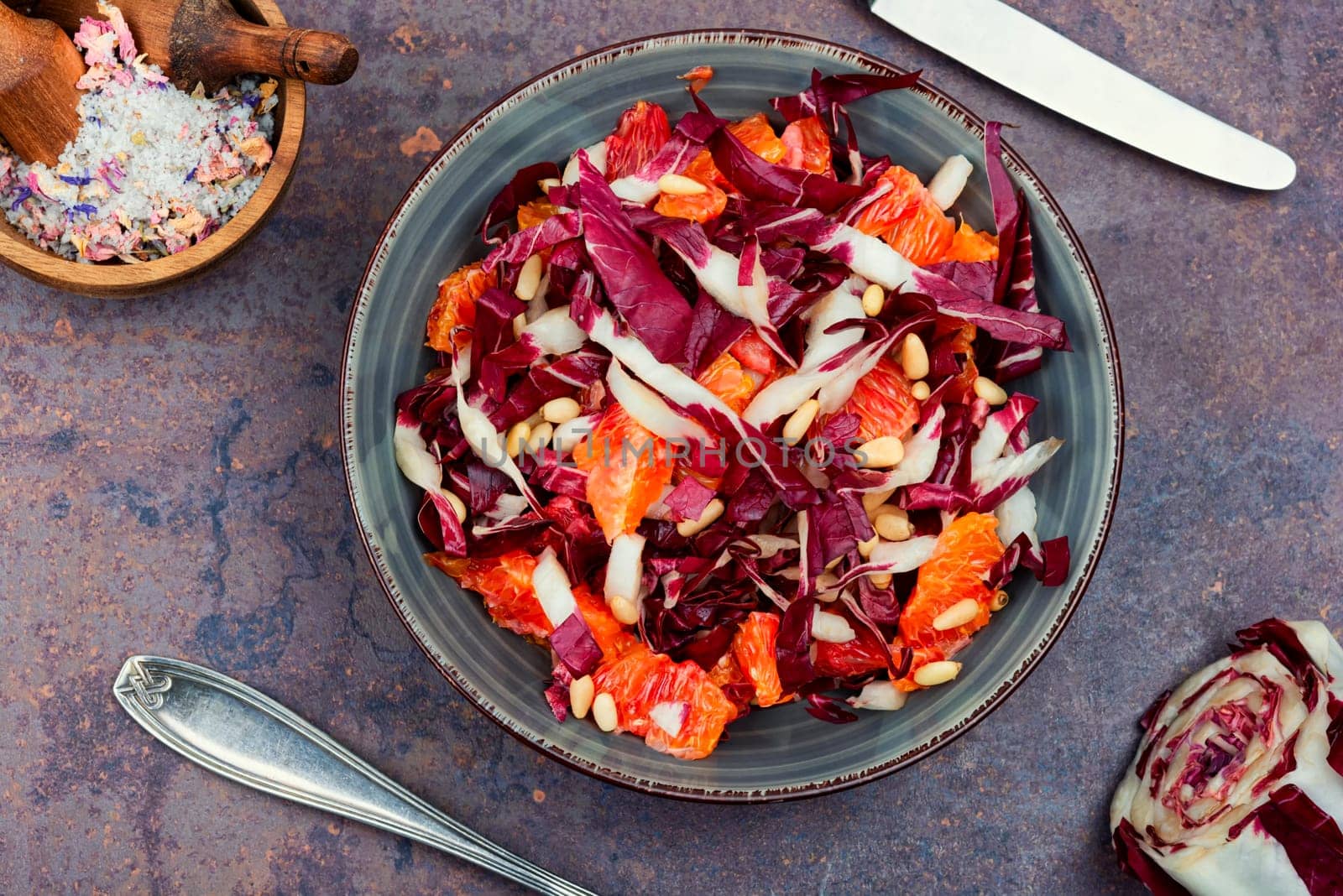 Raw chicory salad with grapefruit and pine nuts on a plate