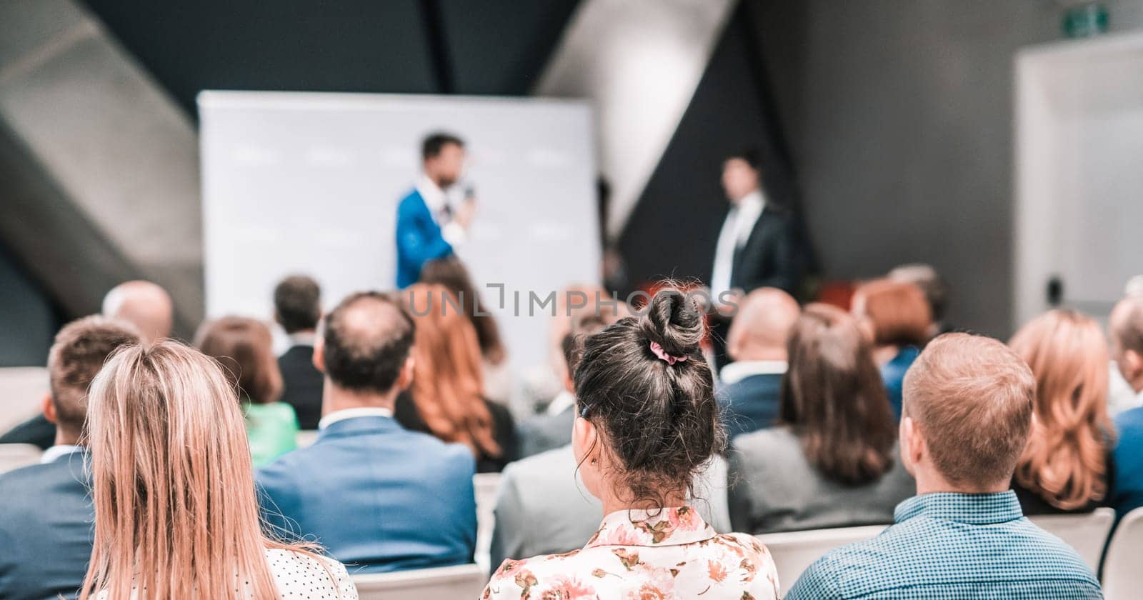 Pitch presentation and project discussion at business convention or team meeting. Audience at the conference hall. Business and entrepreneurship symposium