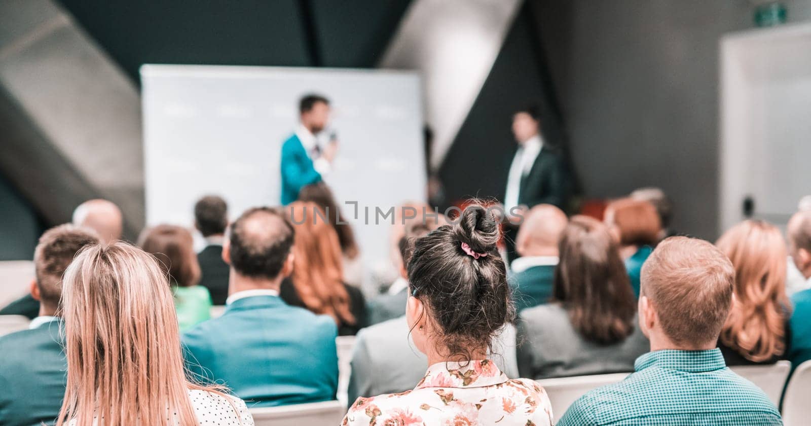 Pitch presentation and project discussion at business convention or team meeting. Audience at the conference hall. Business and entrepreneurship symposium
