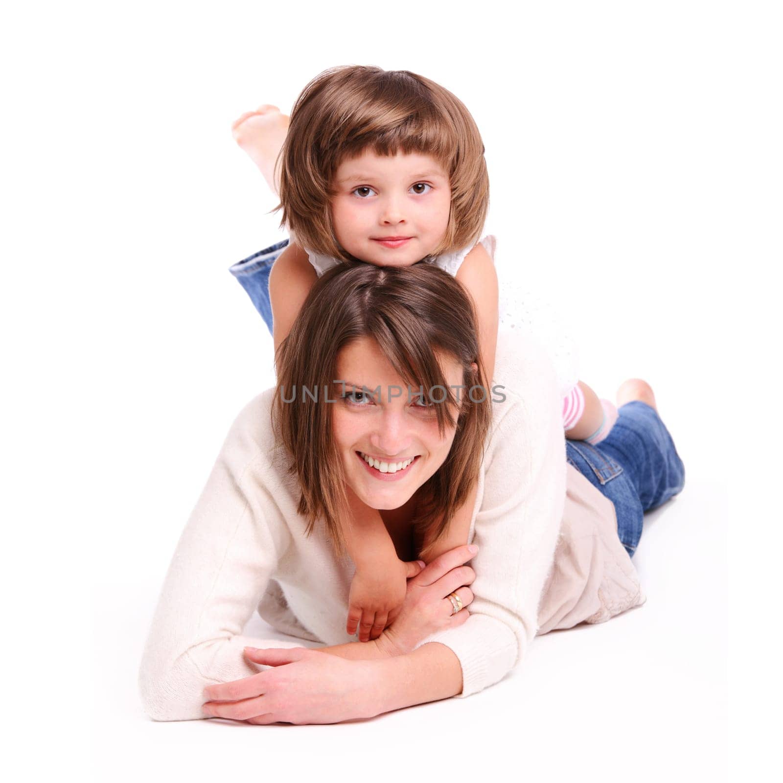 A portrait of a mother and her baby girl lying on the floor and smiling over white background