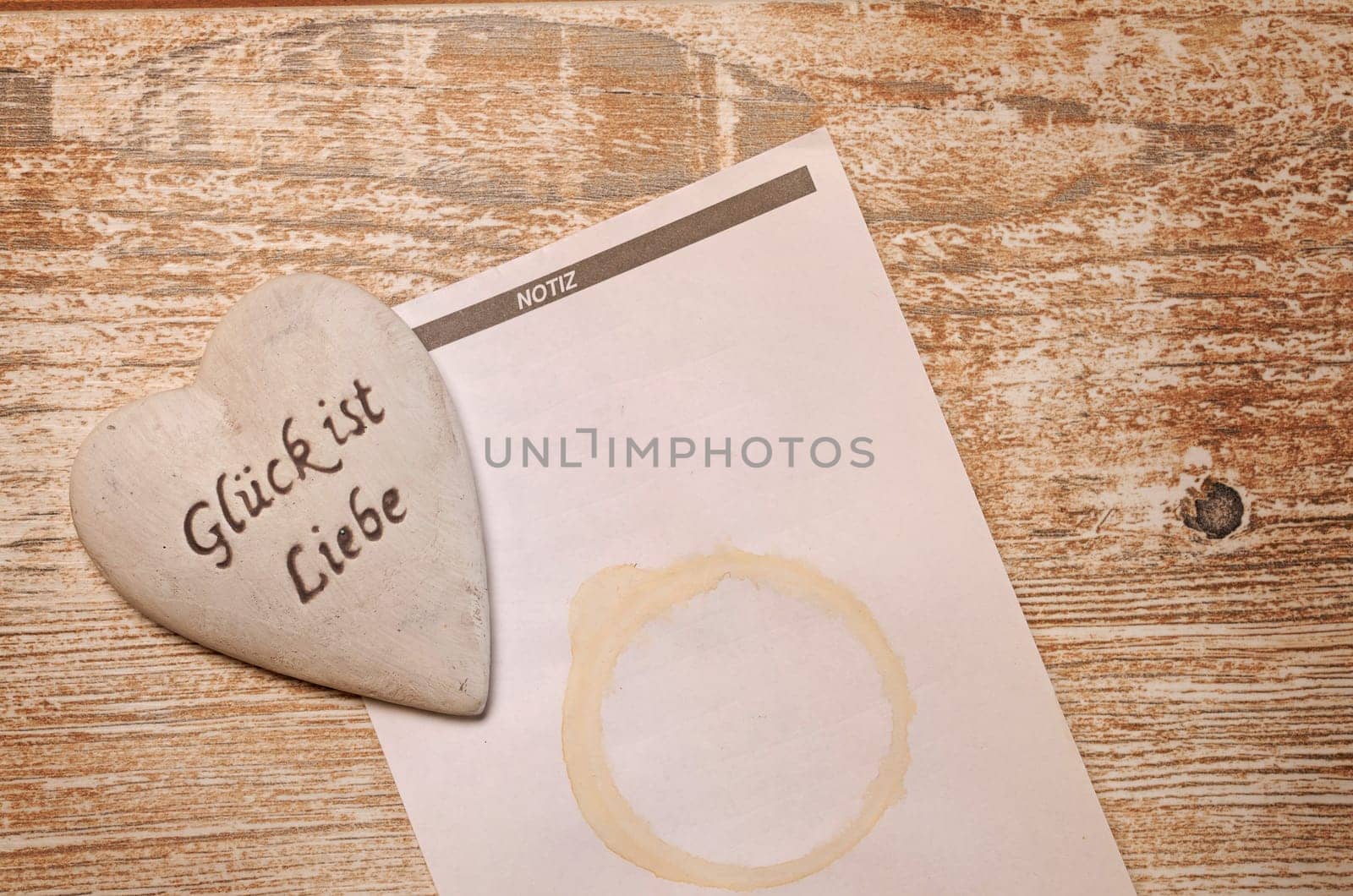 Heart with notepad on a rustic wooden table