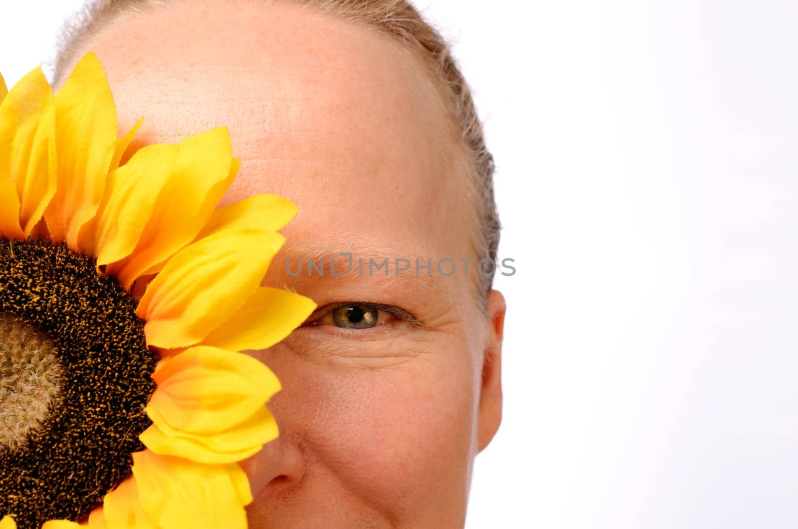 Woman with a sunflower on a white background with space for text