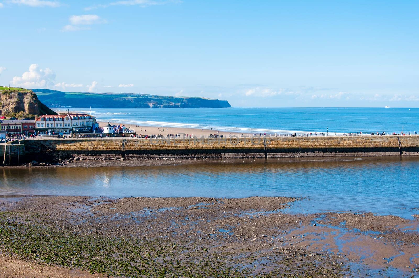 Scenic view of Whitby Pier in sunny autumn day.Whitby's attraction as a tourist destination is enhanced by its association with the world famous horror novel Dracula, written by Bram Stoker