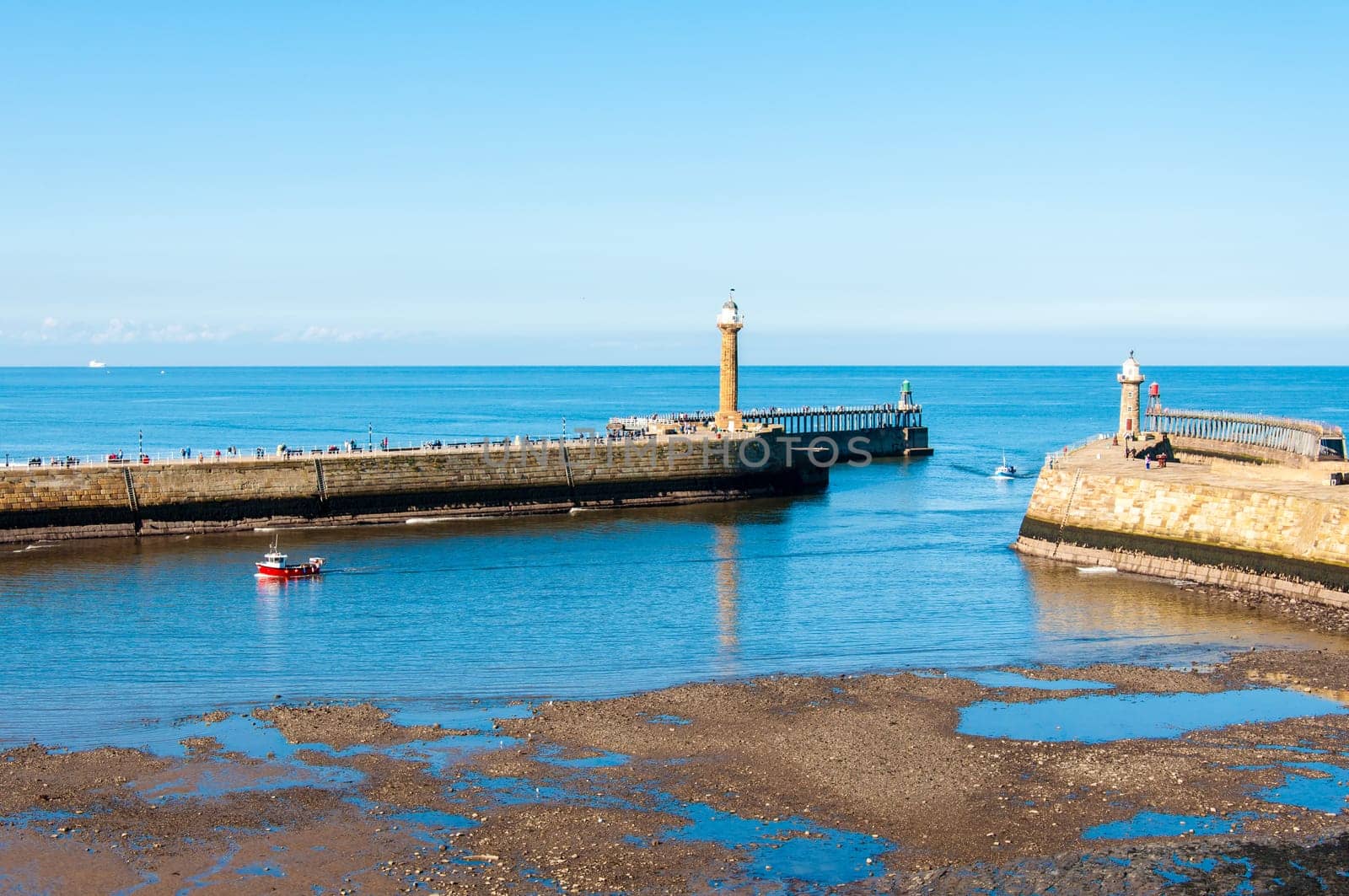 Scenic view of Whitby Pier in sunny autumn day.Whitby's attraction as a tourist destination is enhanced by its association with the world famous horror novel Dracula, written by Bram Stoker