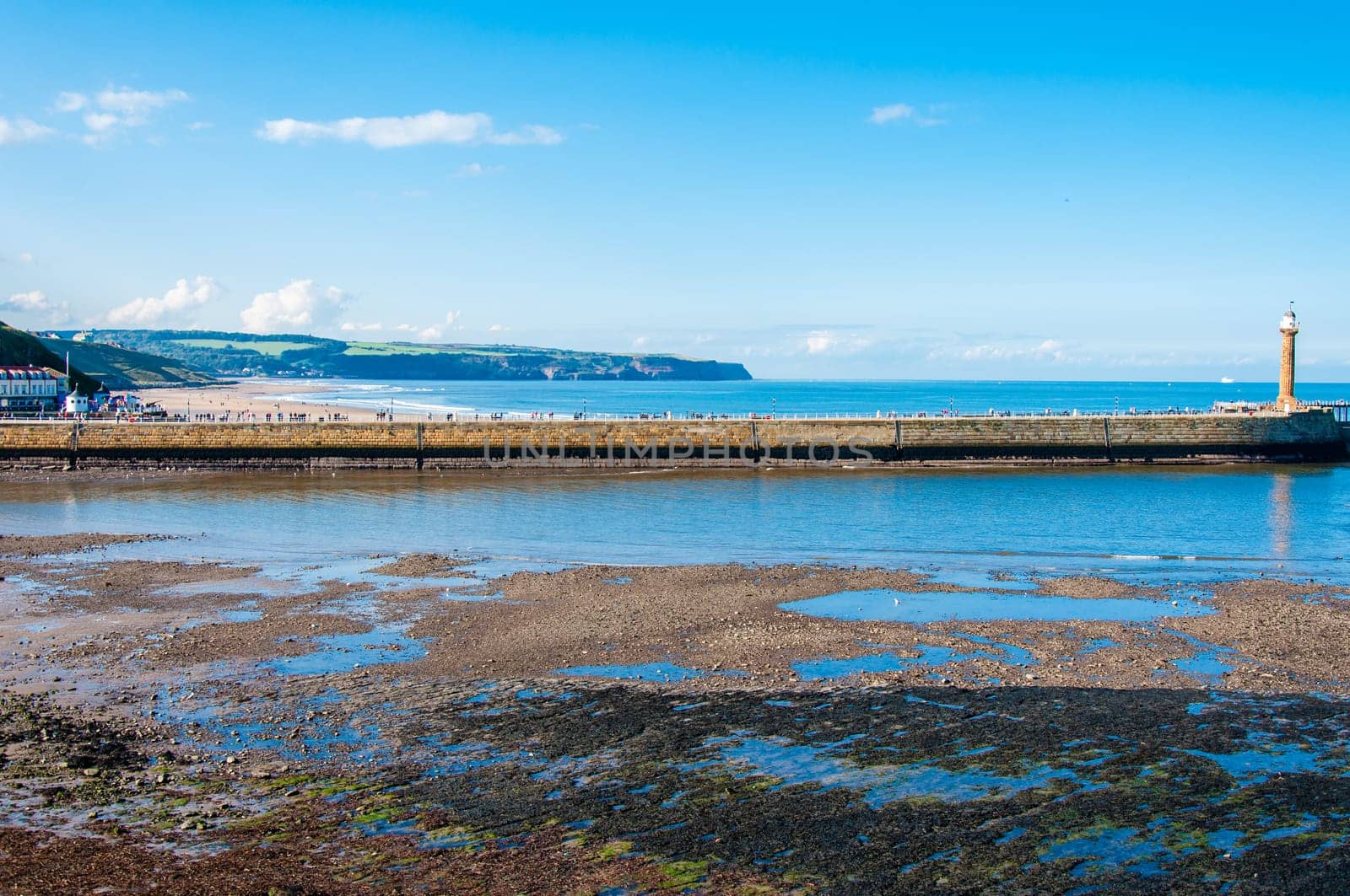 Scenic view of Whitby Pier in sunny autumn day.Whitby's attraction as a tourist destination is enhanced by its association with the world famous horror novel Dracula, written by Bram Stoker