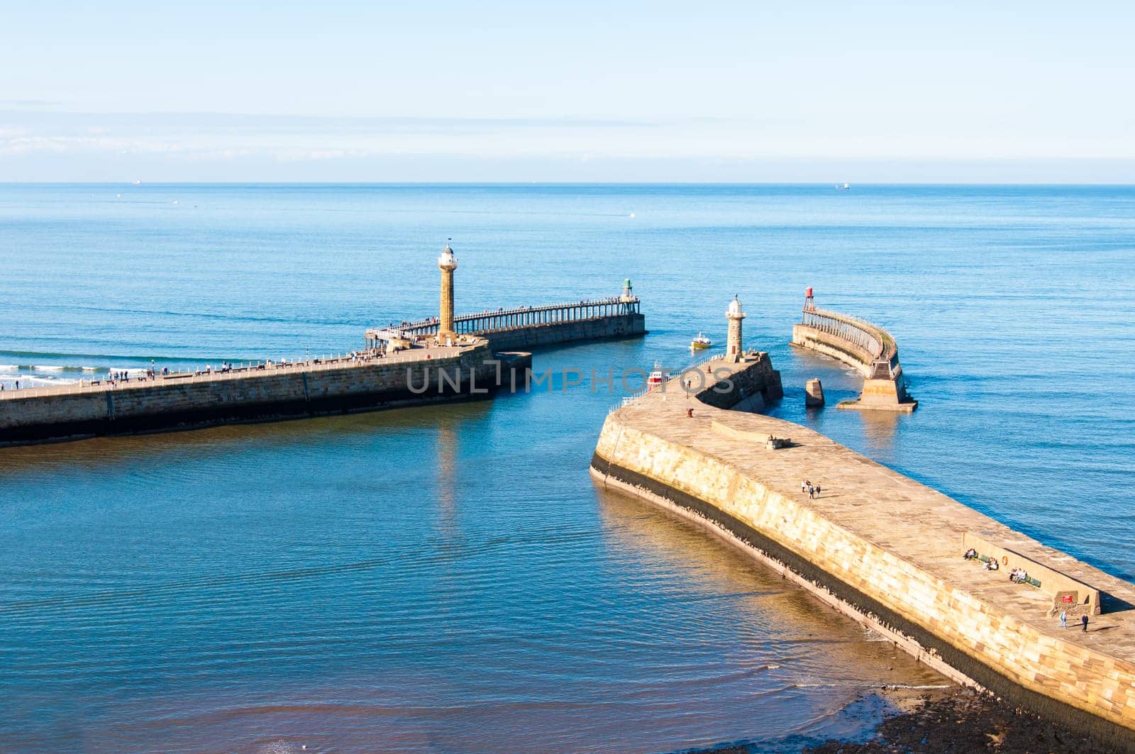 Scenic view of Whitby Pier in sunny autumn day.Whitby's attraction as a tourist destination is enhanced by its association with the world famous horror novel Dracula, written by Bram Stoker