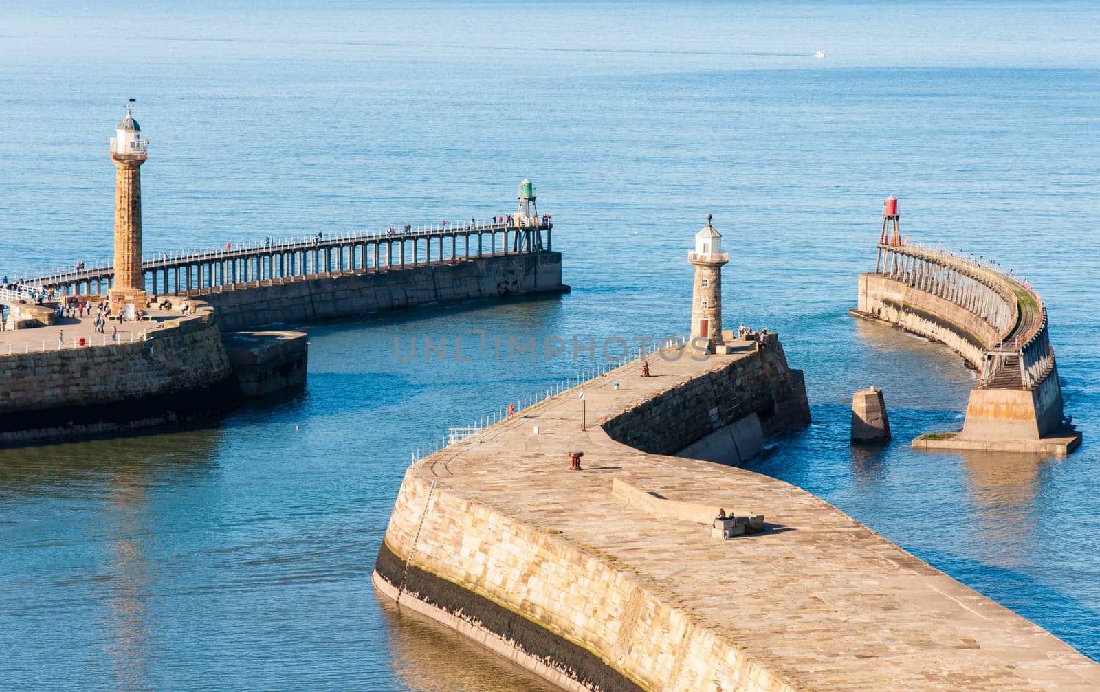 Scenic view of Whitby Pier in sunny autumn day.Whitby's attraction as a tourist destination is enhanced by its association with the world famous horror novel Dracula, written by Bram Stoker