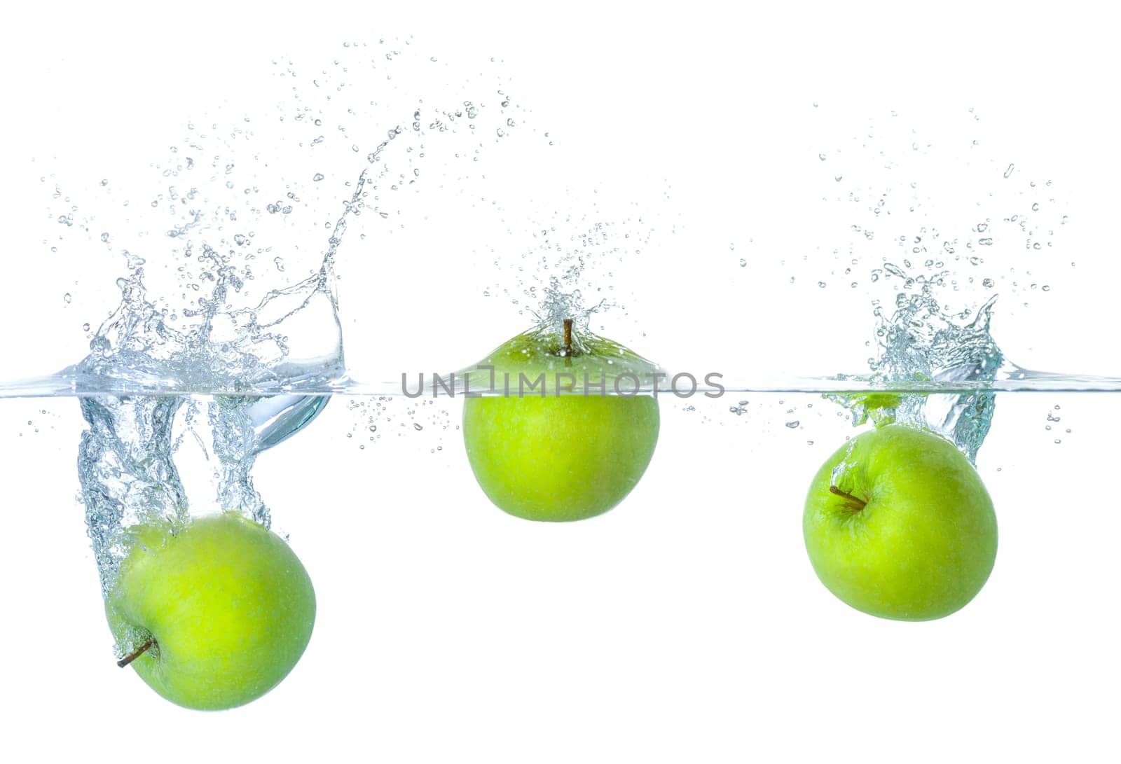 Apples fall into the water with splashes