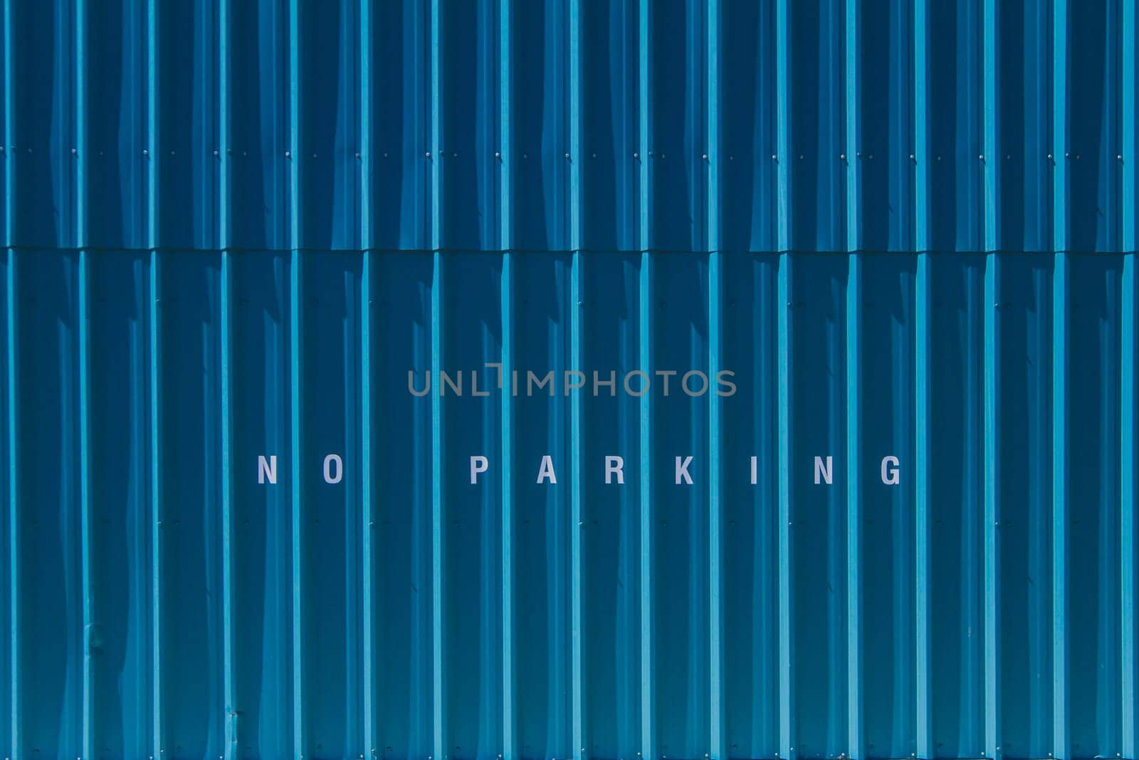 No parking printed on blue siding.