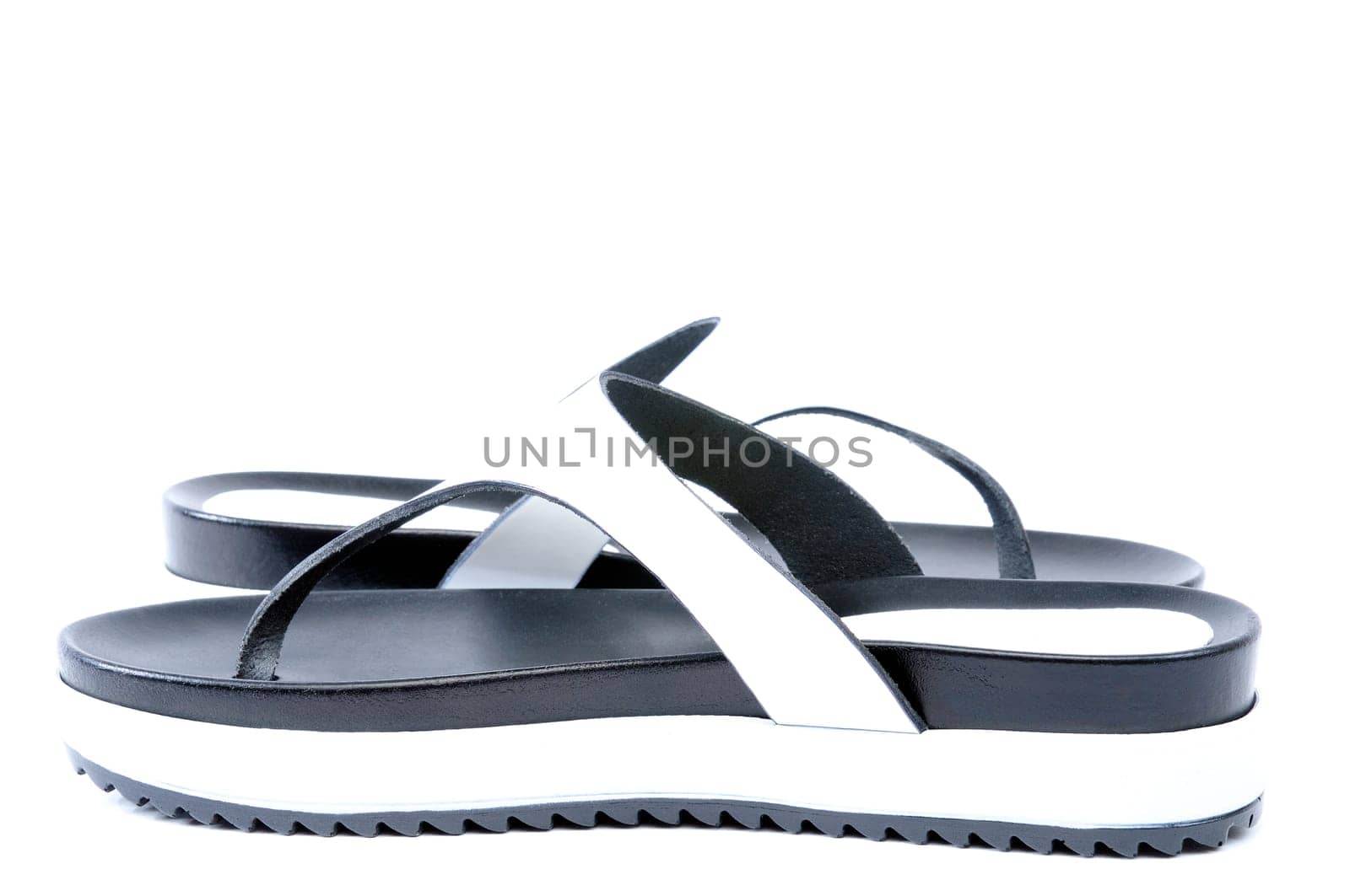 Leather flip flops photographed in studio on white background