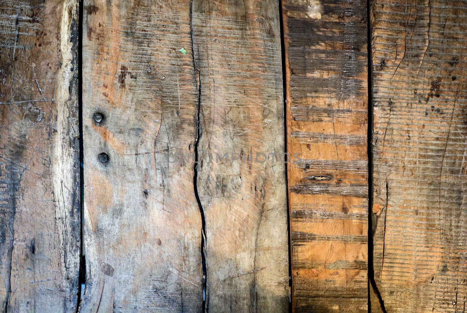 Wooden boards lying next to each other. A wood texture made of several wooden boards.