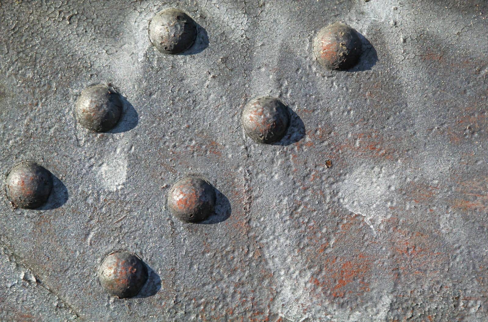 Steel rivets, rivets on an iron beam. Texture from a steel beam and rivets in arrangement.