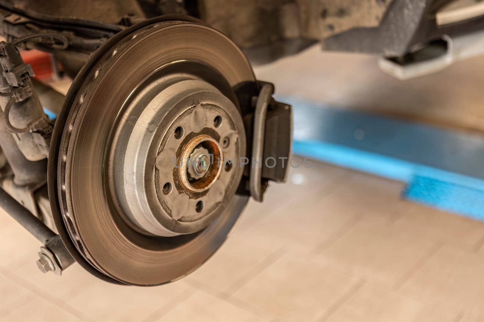 Close-up shot of a mechanic replacing a disc brake on a car