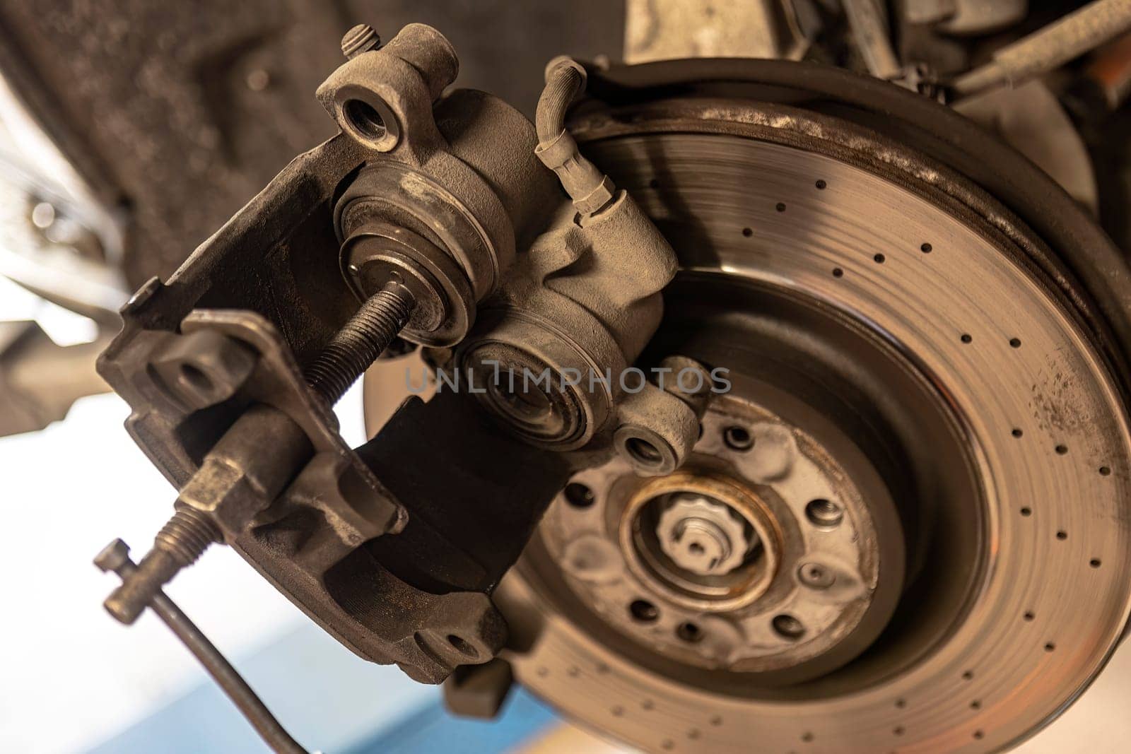 Close-up shot of a mechanic replacing a disc brake on a car