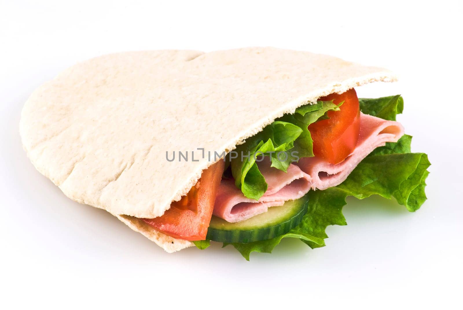 Pitta bread pocket filled with salad tomato cucumber and ham