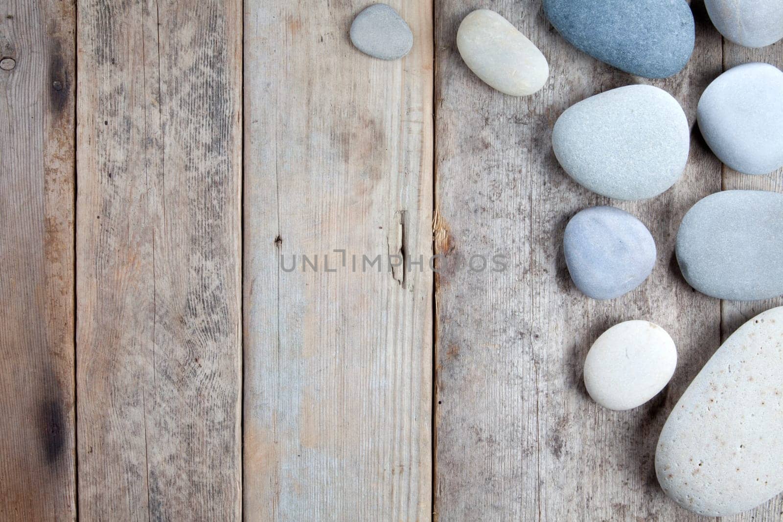 Stones with shadow on wooden background