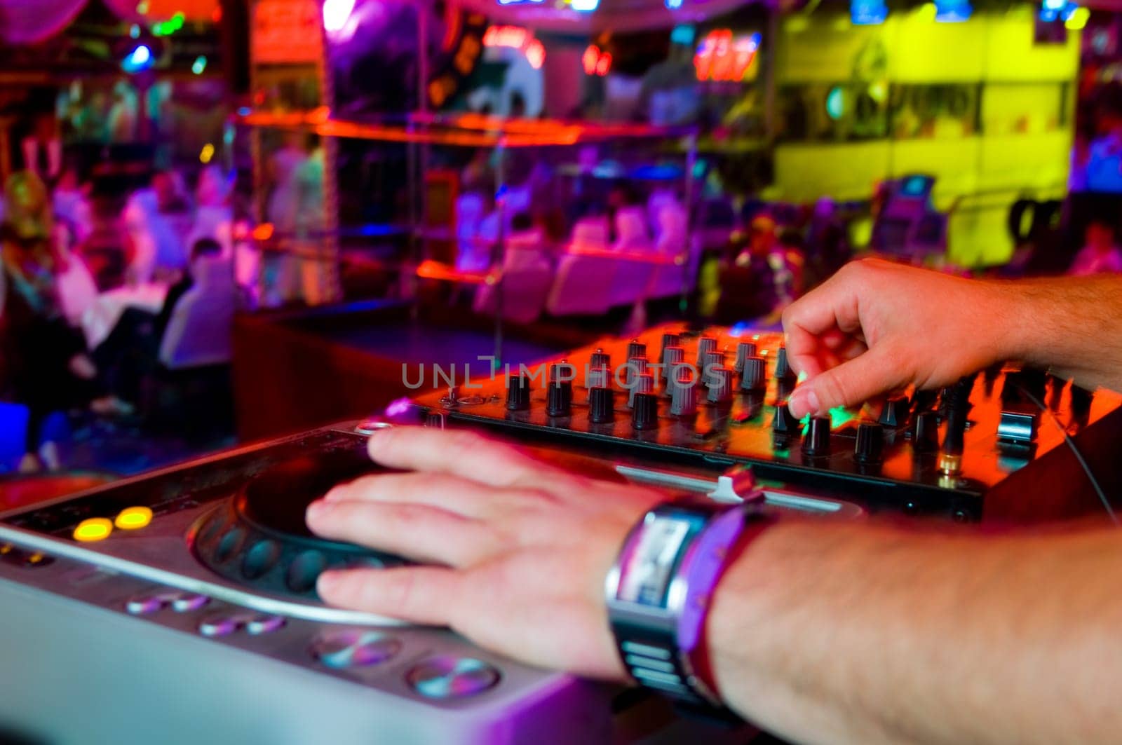 Dj playing the track in the nightclub at a party