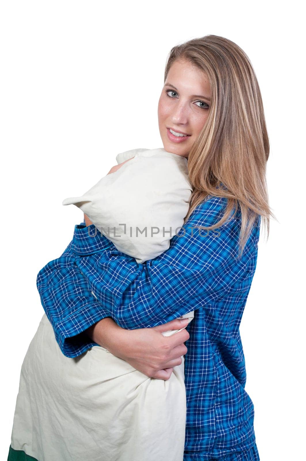 A beautiful young woman wearing pajamas hugging her pillow