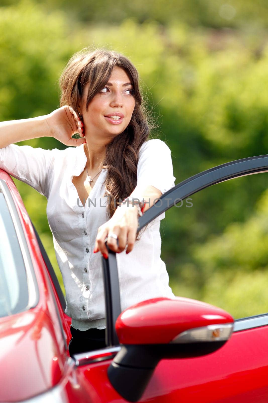 Young pretty woman in the red car
