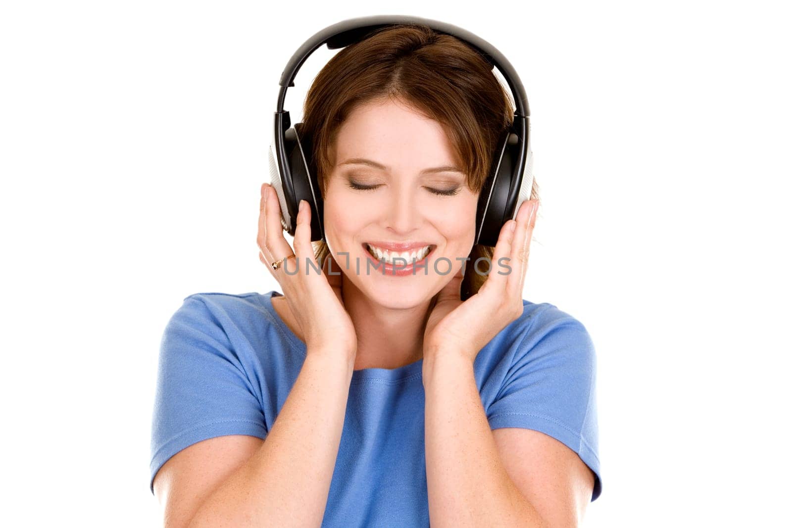 pretty casual brunette is listening to music on white background