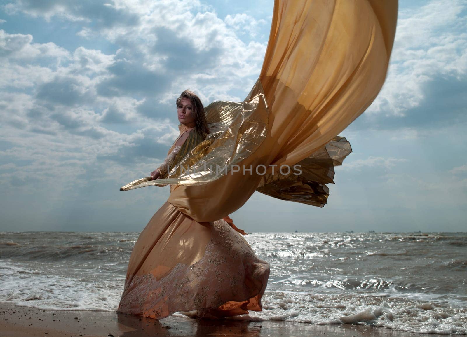 beautiful woman in exotic dress standing on the beach. Sea ​​of ​​Azov