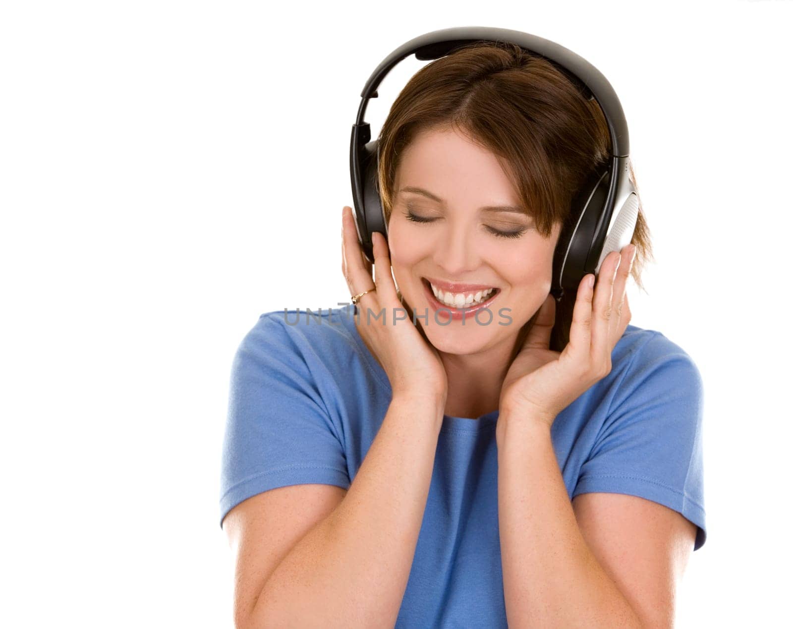 pretty casual brunette is listening to music on white background
