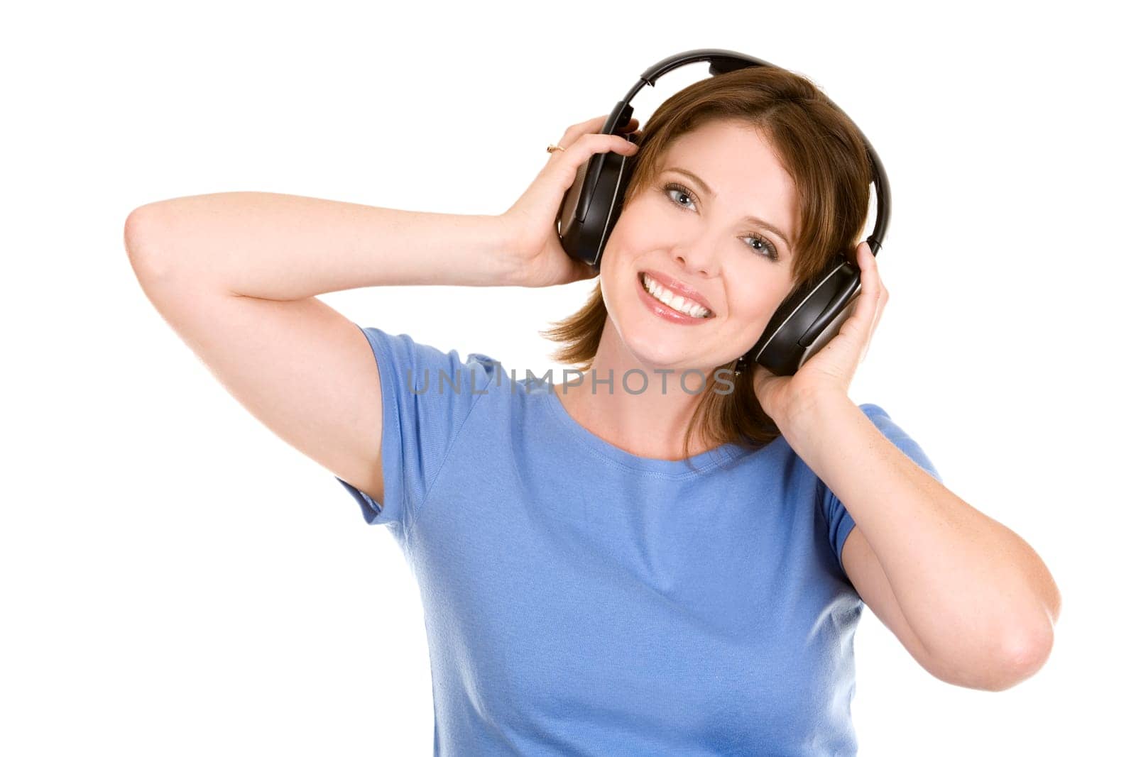pretty casual brunette is listening to music on white background