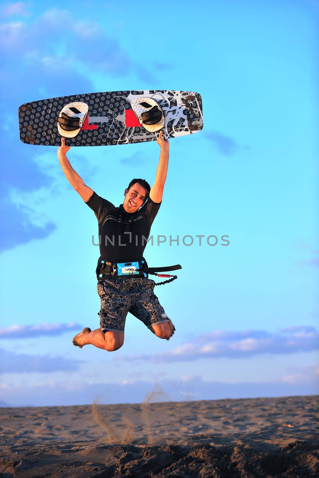 Portrait of a strong young  surf  man at beach on sunset in a contemplative mood with a surfboard