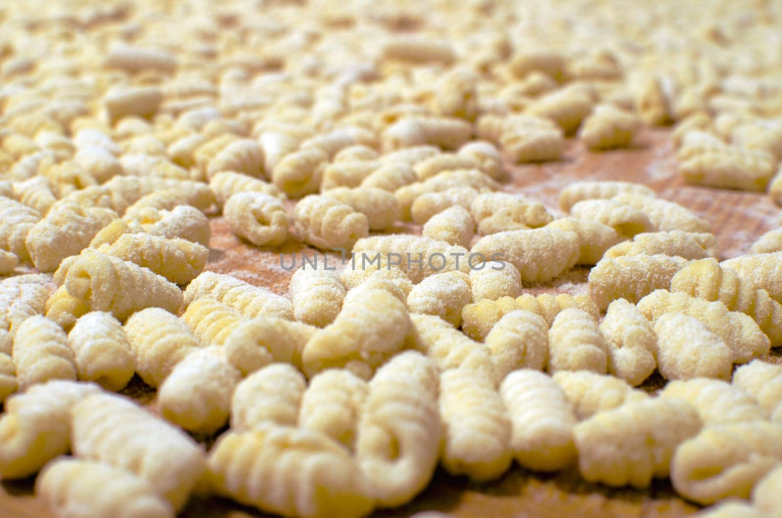 Uncooked gnocchi - background with traditional italian pasta