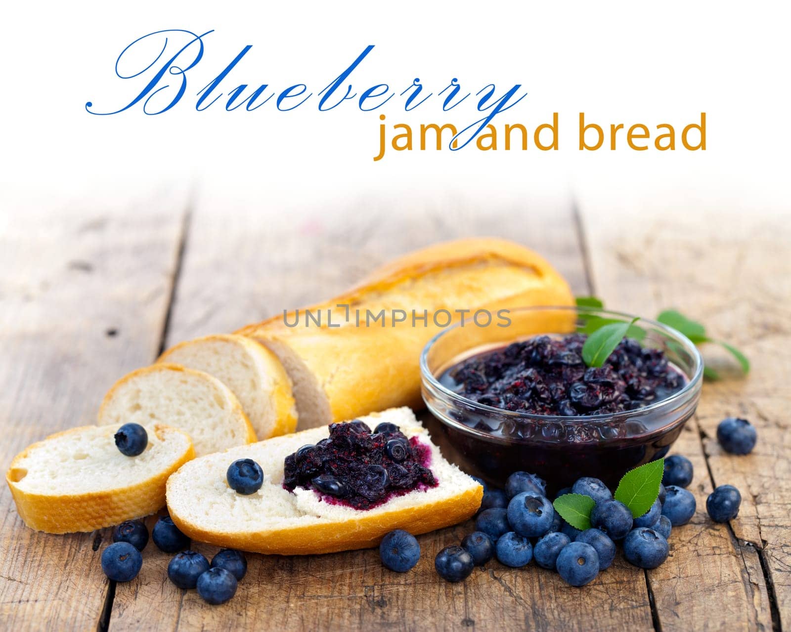 Fresh bread with blueberry jam and fruits on a rustic table, place for your text up