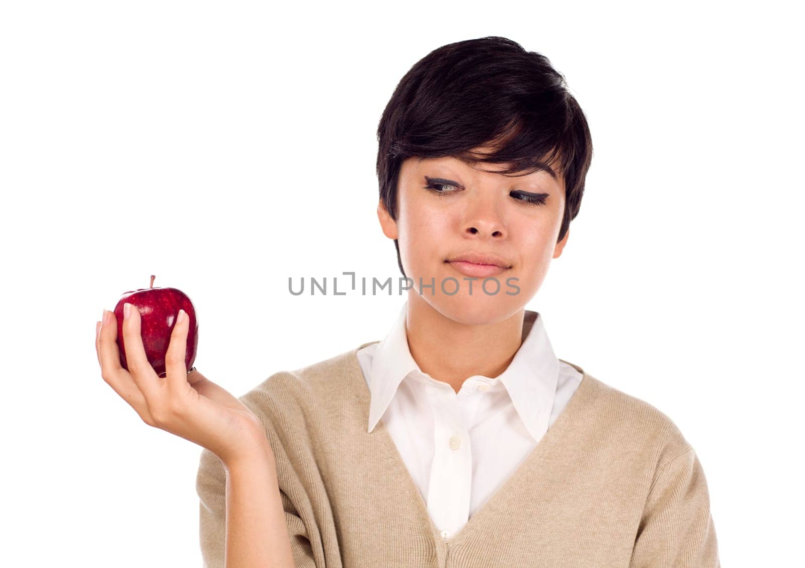 Pretty Hispanic Young Adult Female Looking at Apple in Hand Isolated on a White Background.